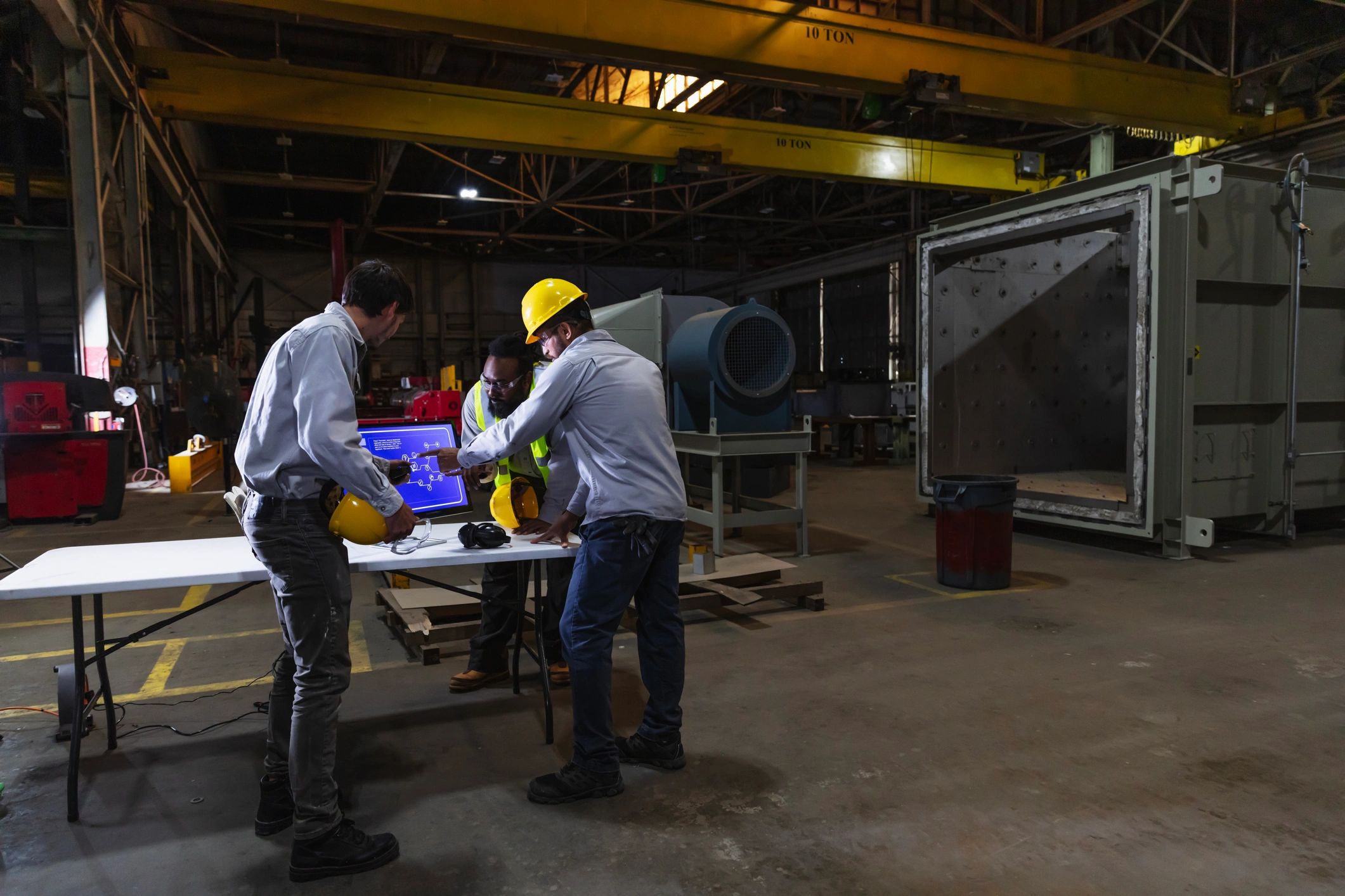 Industrial team reviewing technical information on a factory floor
